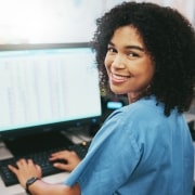 Smiling medical receptionist on the computer