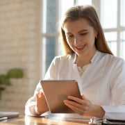 Smiling medical professional holding a tablet