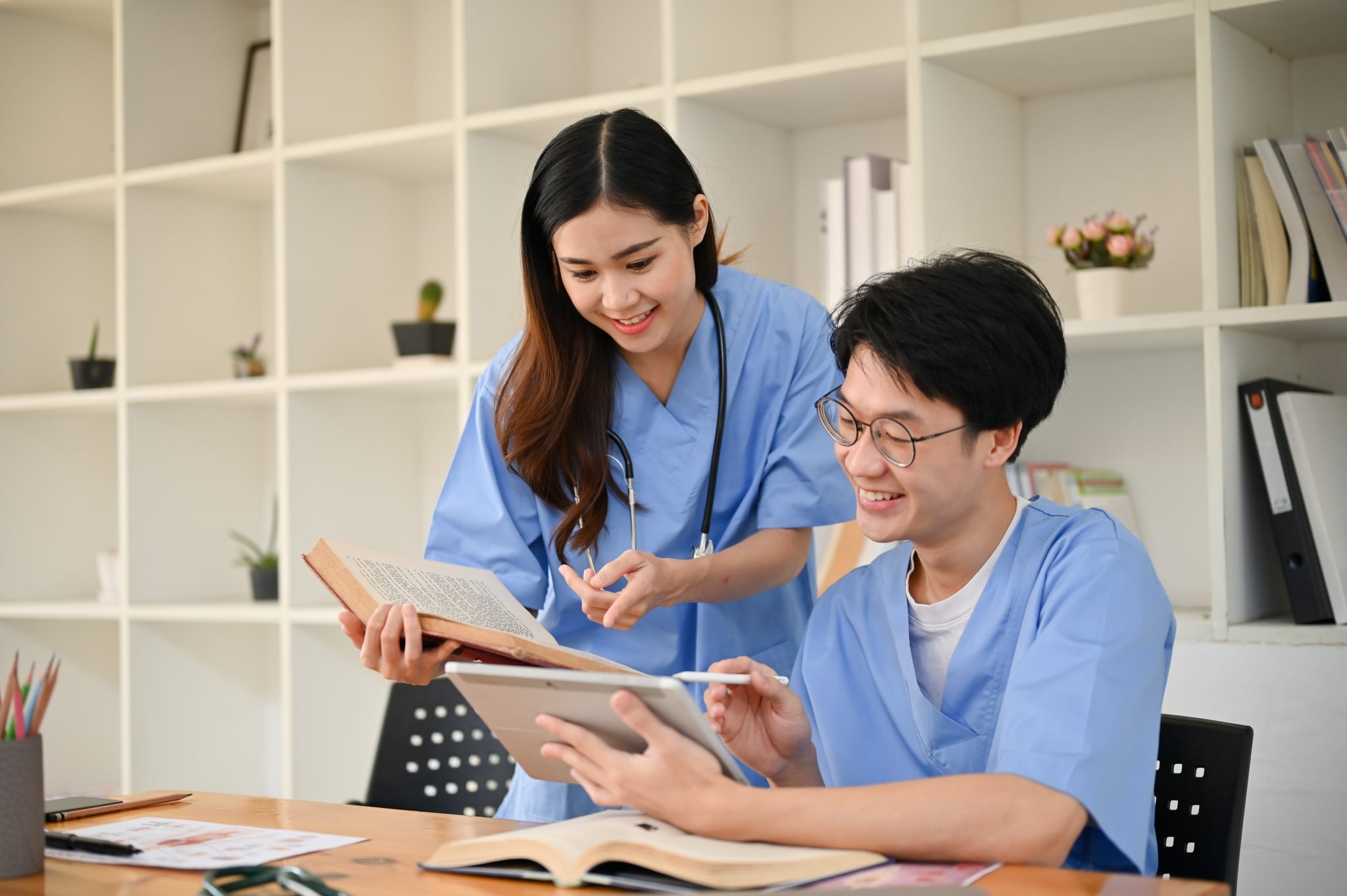 Two Asian medical students studying together
