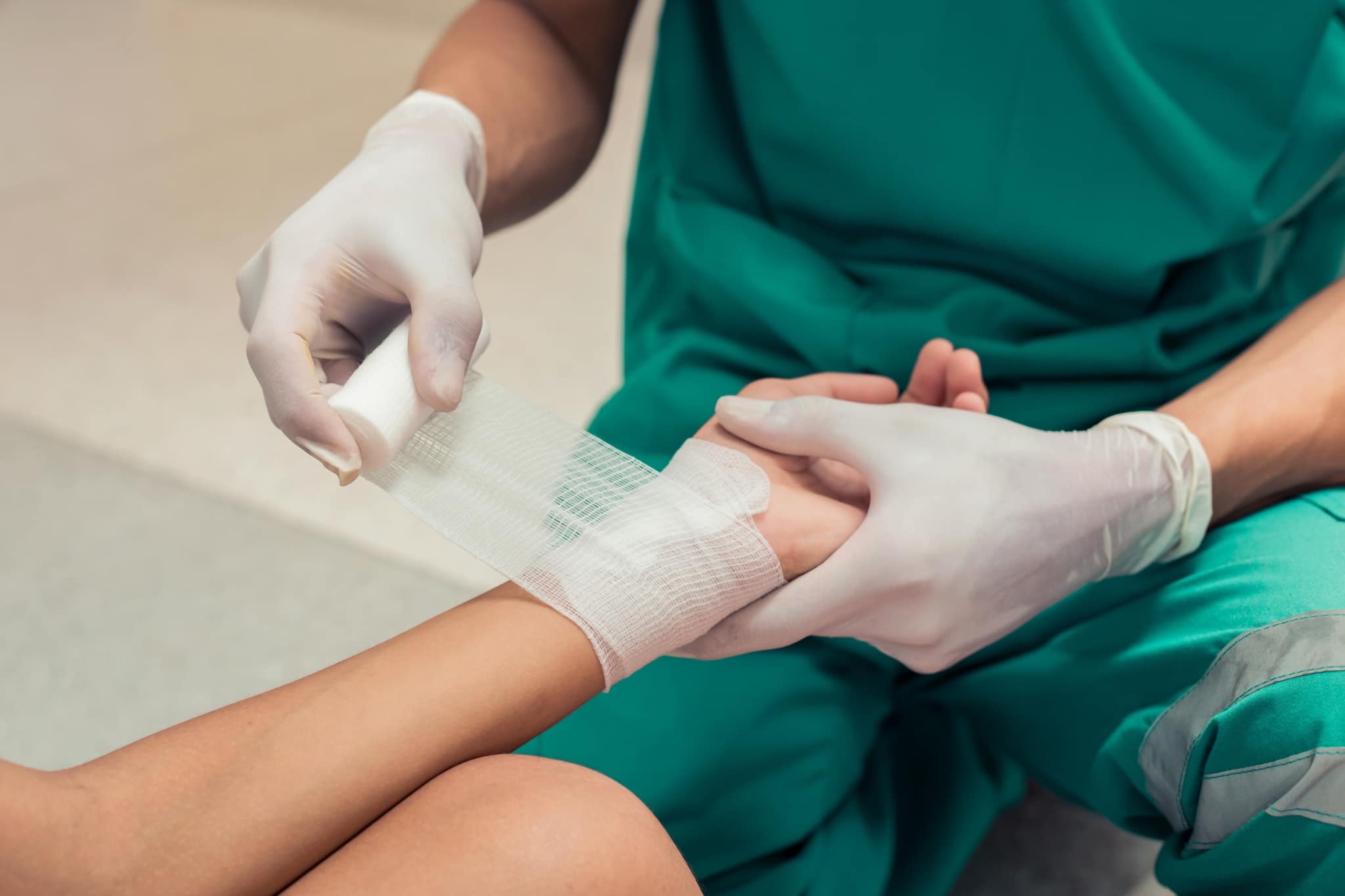 Close up of a medical professional bandaging a wound
