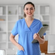 Medical Assistant with a clipboard at a clinic