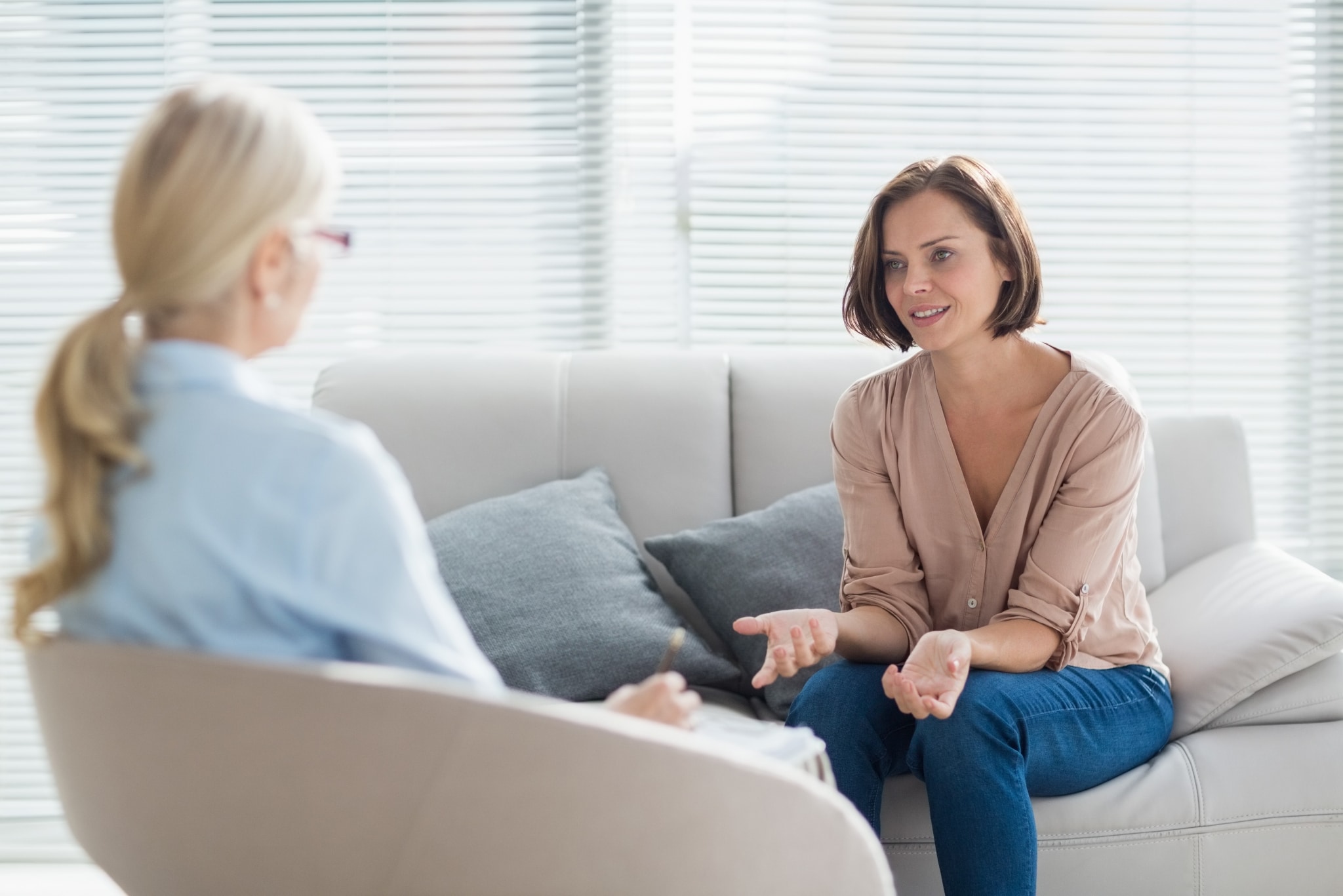 Woman in a therapy session with a female therapist