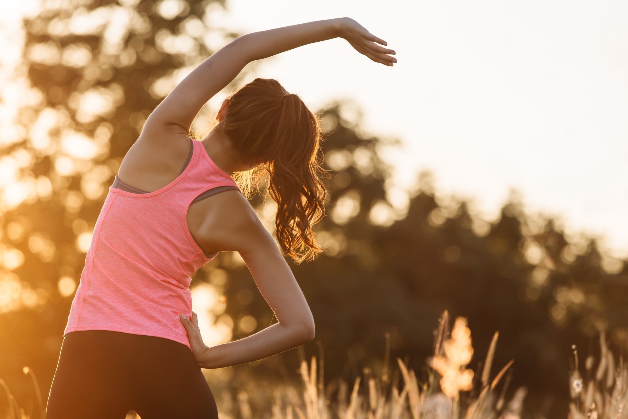 Woman wearing exercise gear and stretching