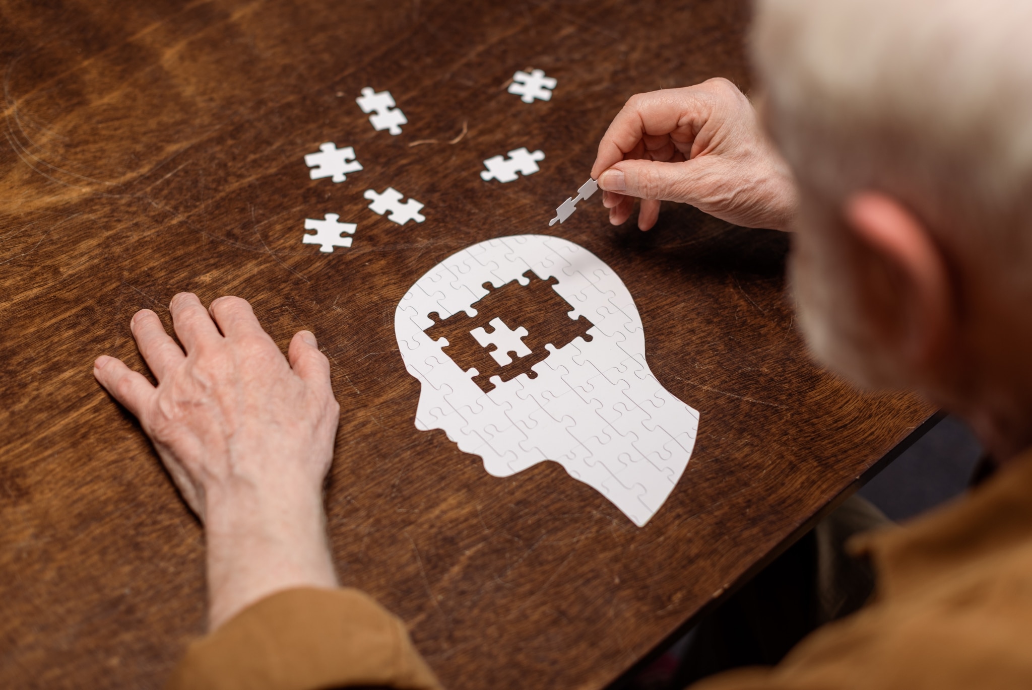 Elderly man completing a puzzle in a rehabilitation clinic