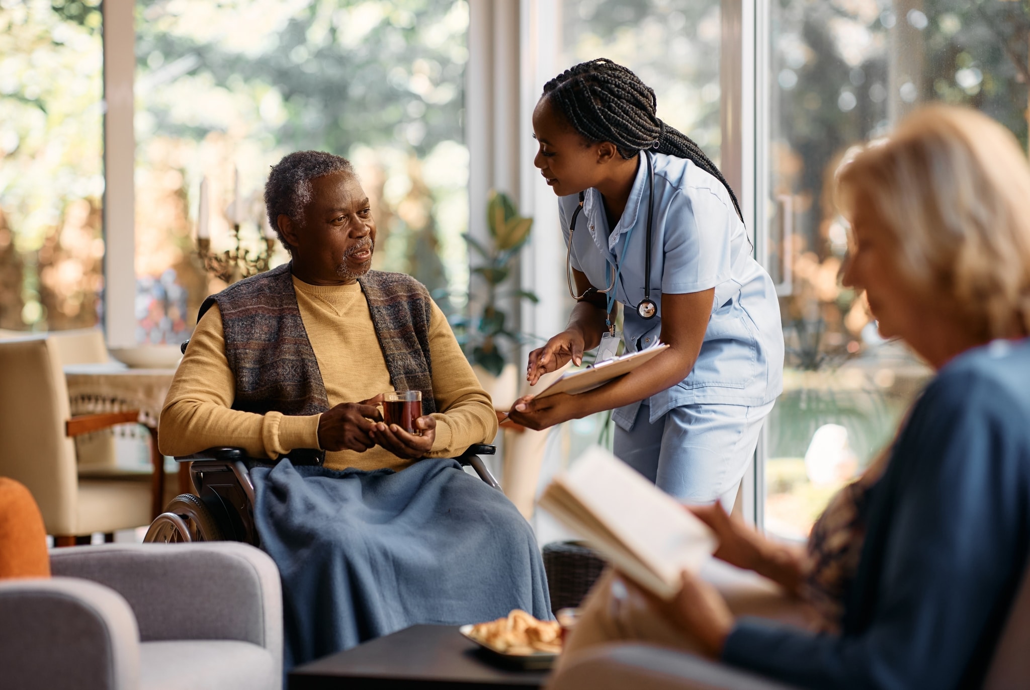 African-American nurse consulting with an elderly patient