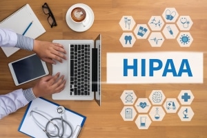 Aerial view of a man on a laptop and virtual symbols next to a sign that says HIPAA