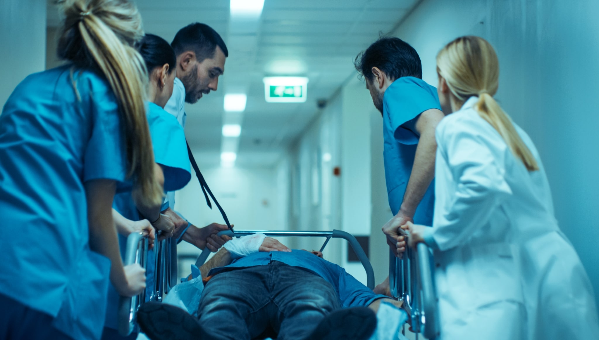 Team of medical professionals rushing to transport a patient