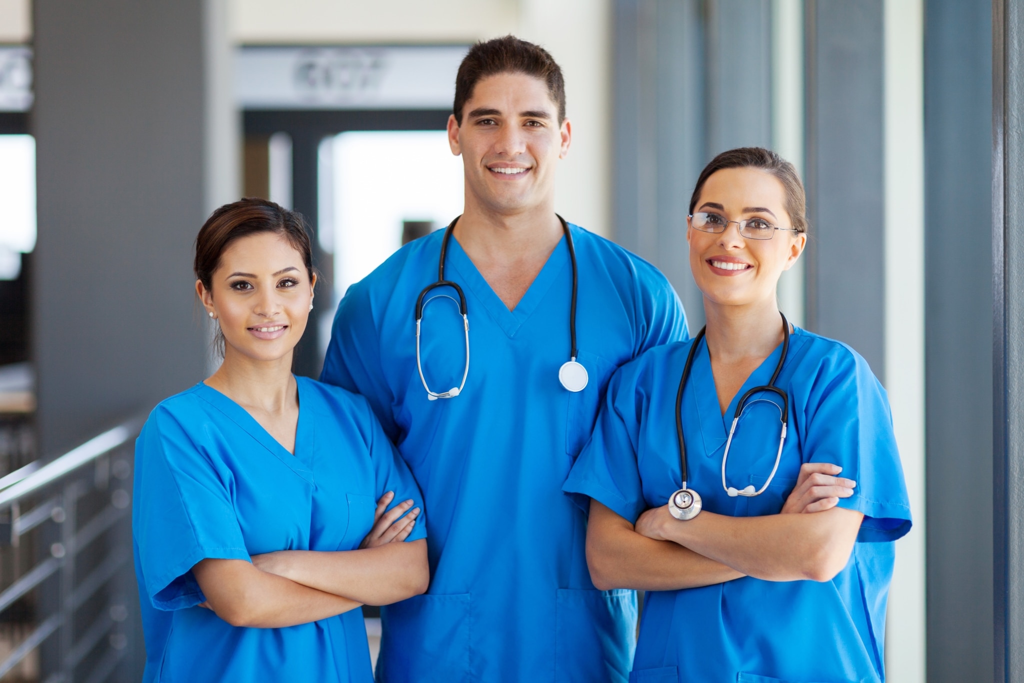 Three medical professionals standing in a hospital