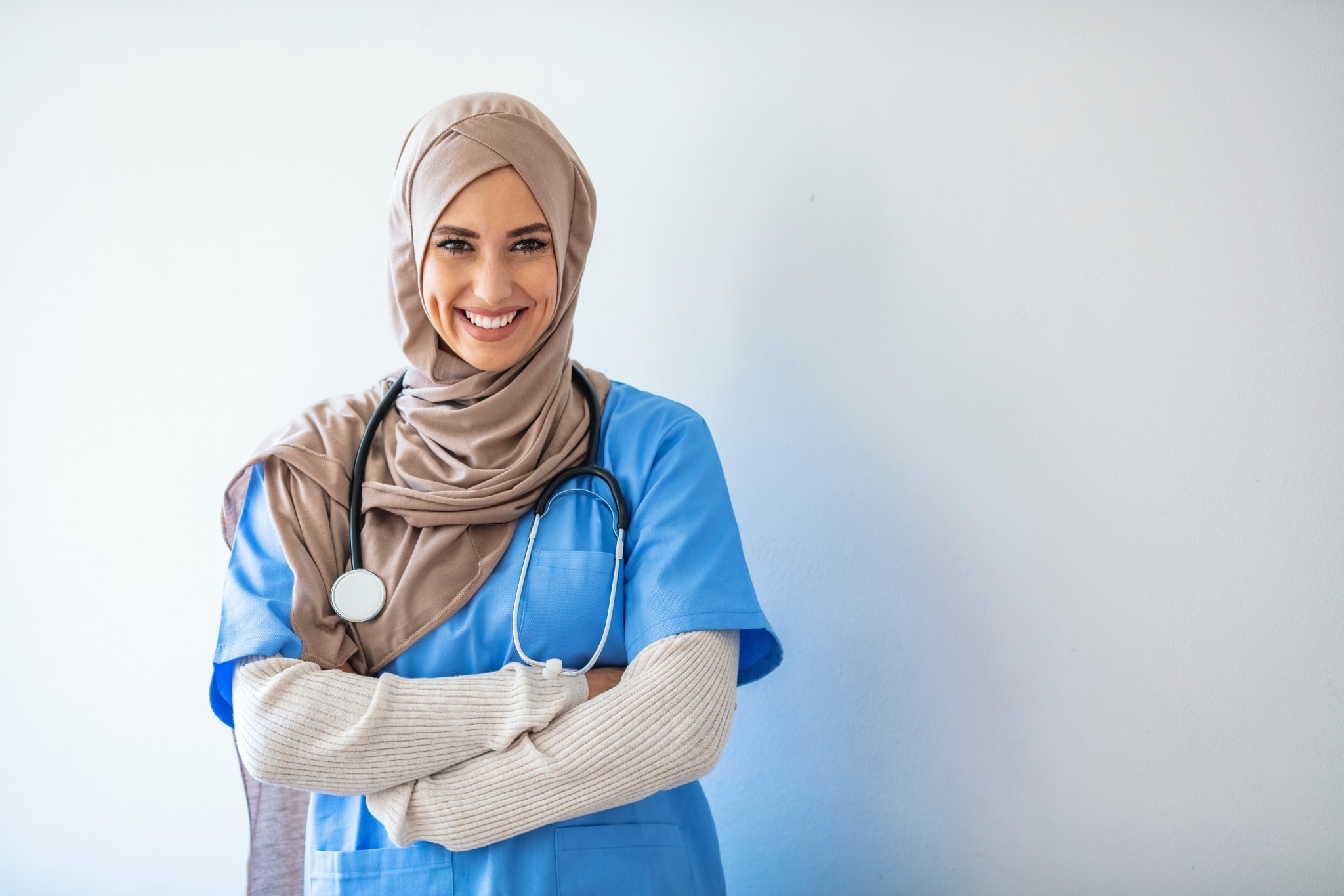 Smiling nurse wearing scrubs and a hijab