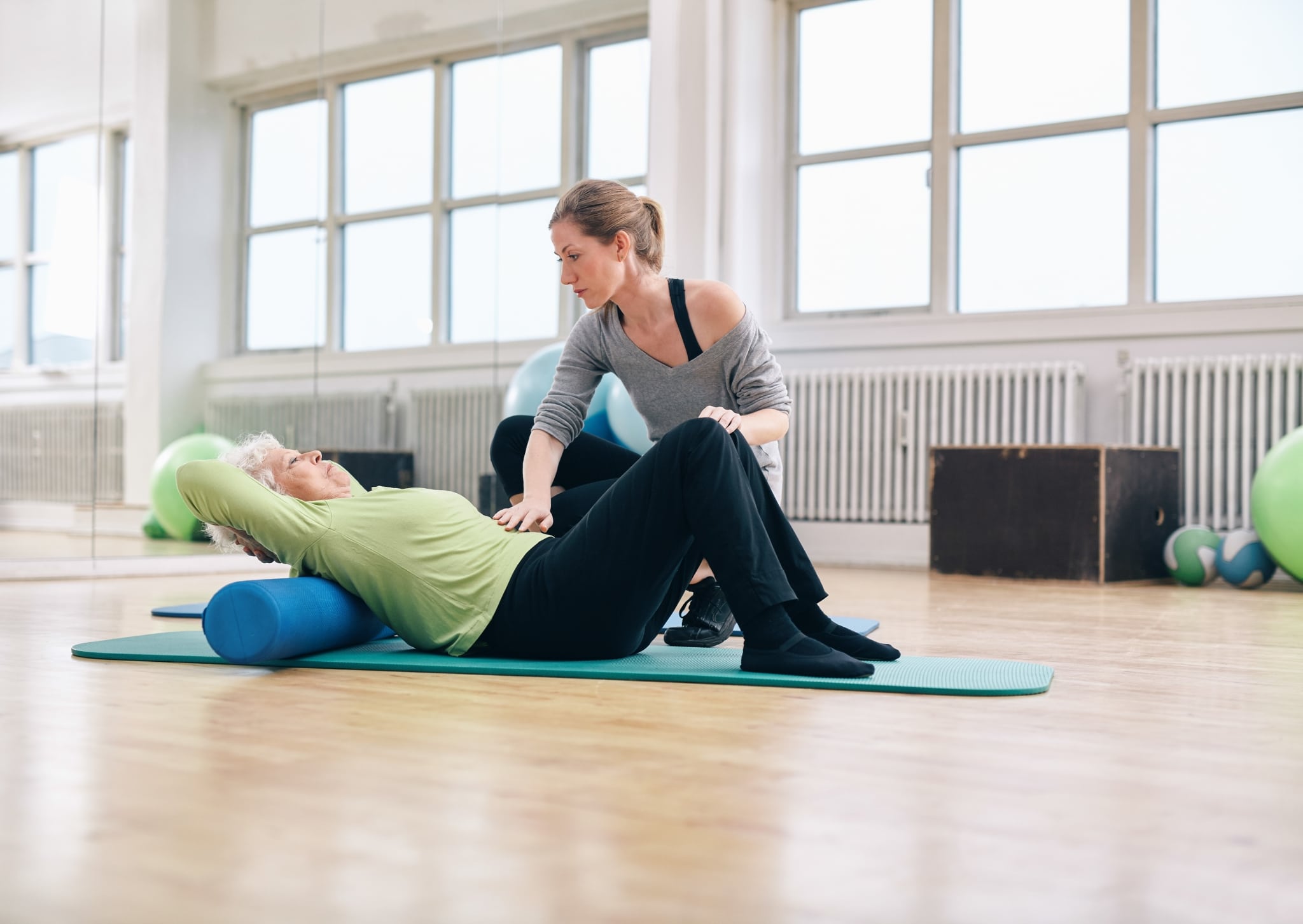 Elderly woman performing exercises in physical therapy