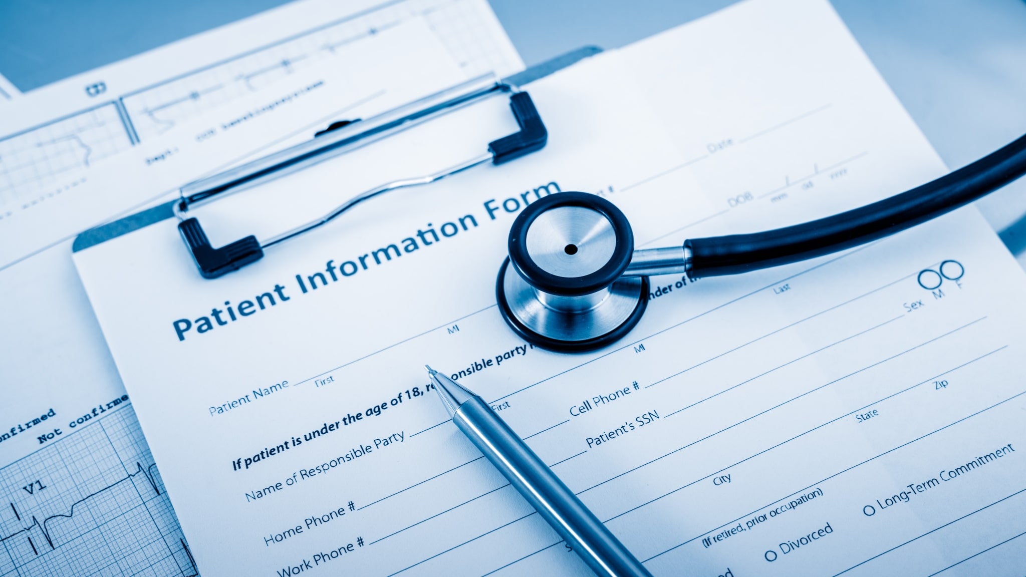 Close up of a stethoscope and patient information forms