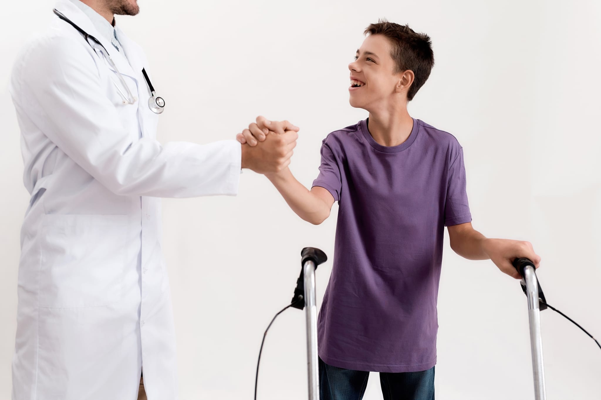 Young boy with cerebral palsy shaking hands with a doctor