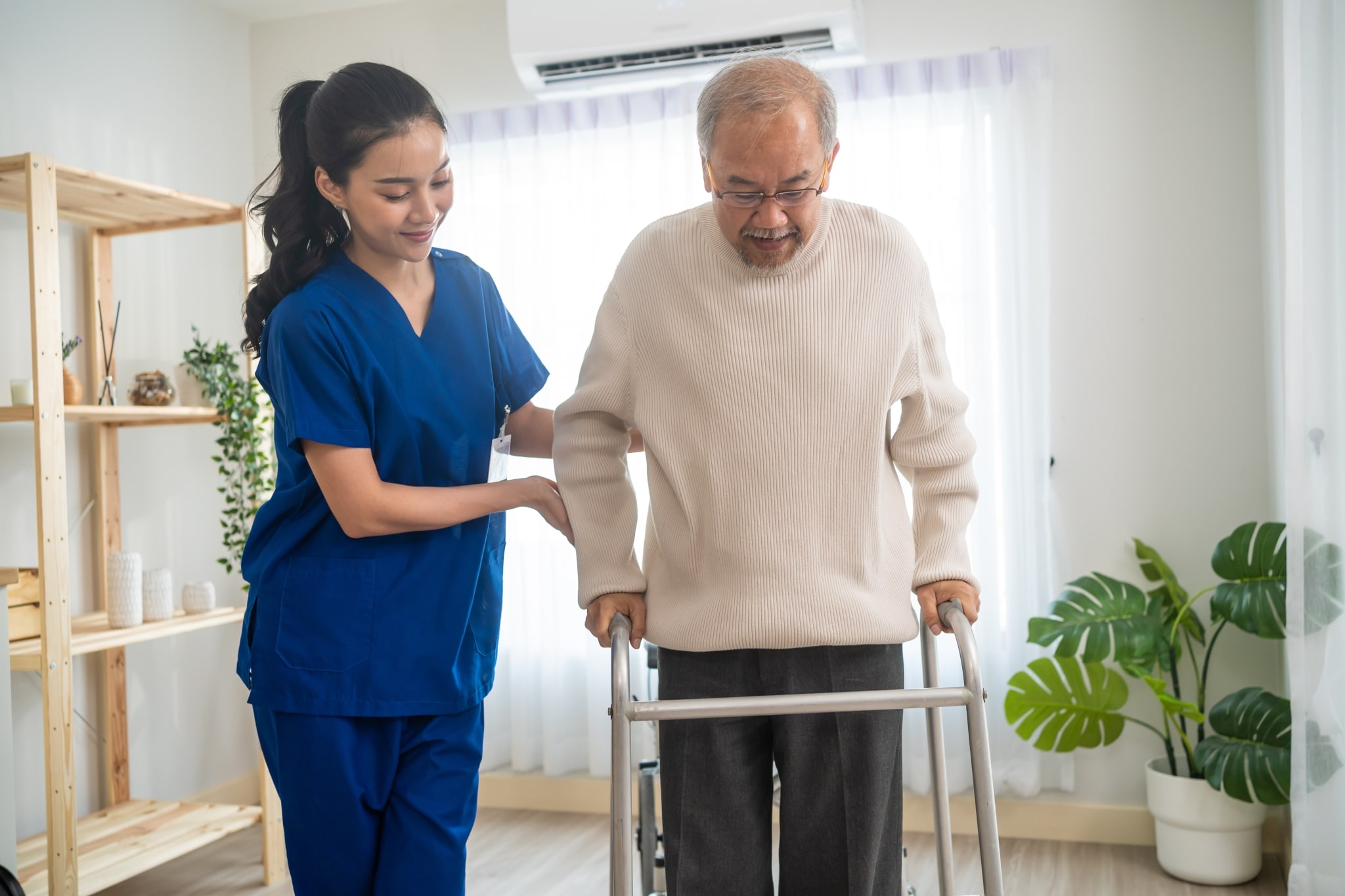 Asian man in occupational therapy with a caregiver