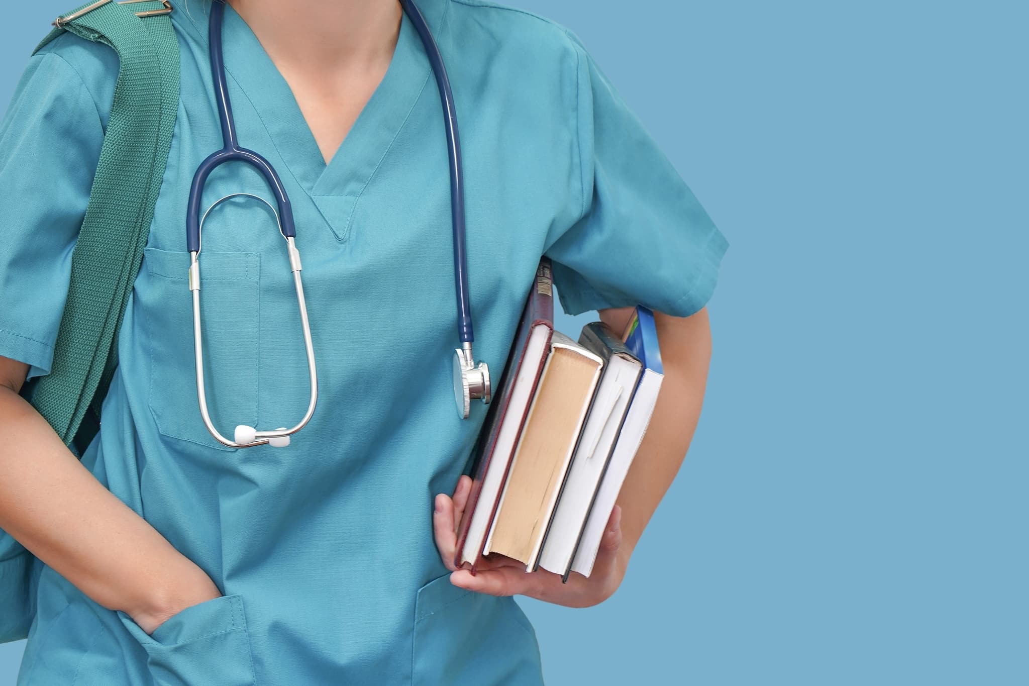Close up of a medical student holding textbooks