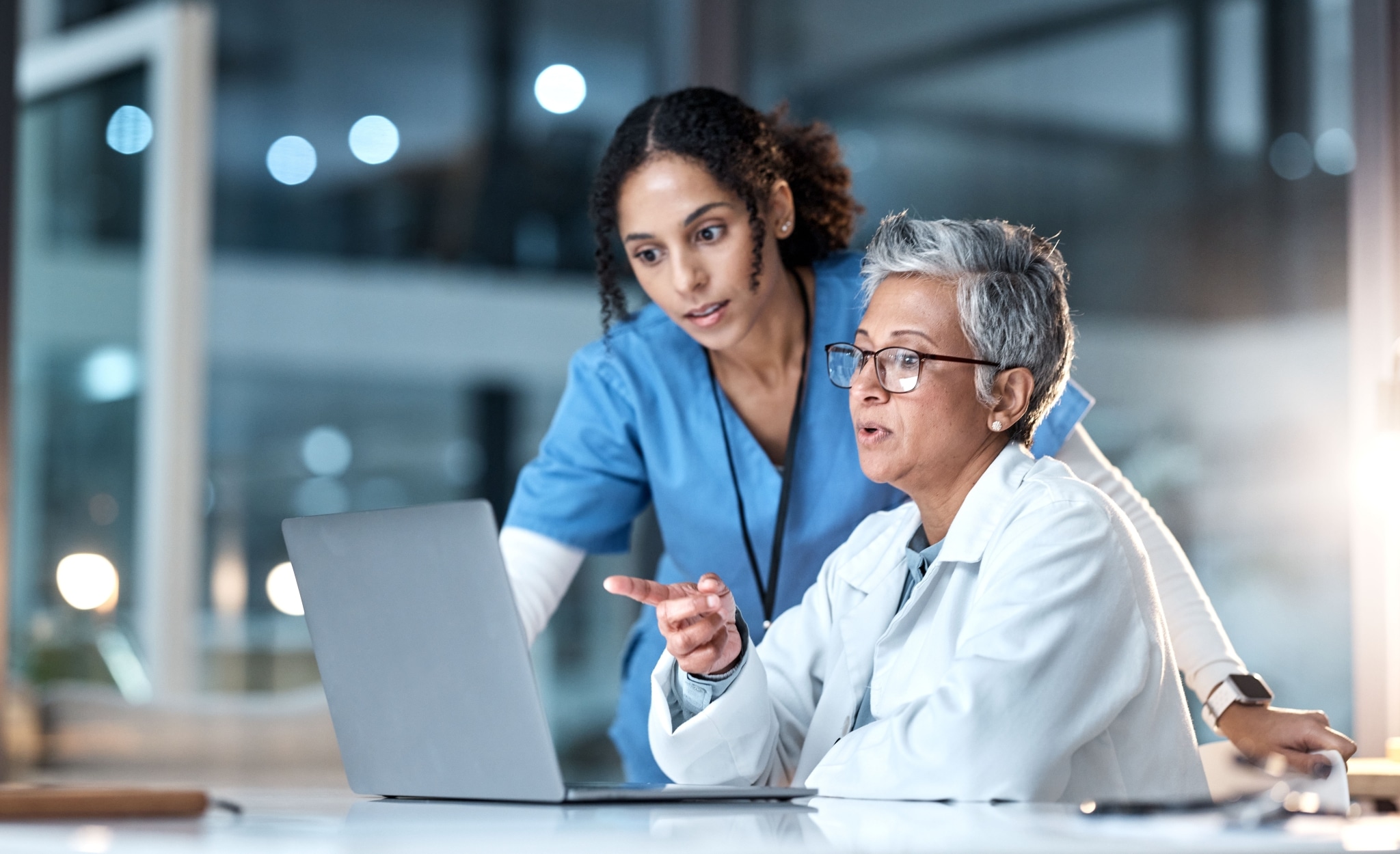 Nurse and doctor using a laptop together