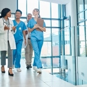 Group of smiling medical professionals in a hallway