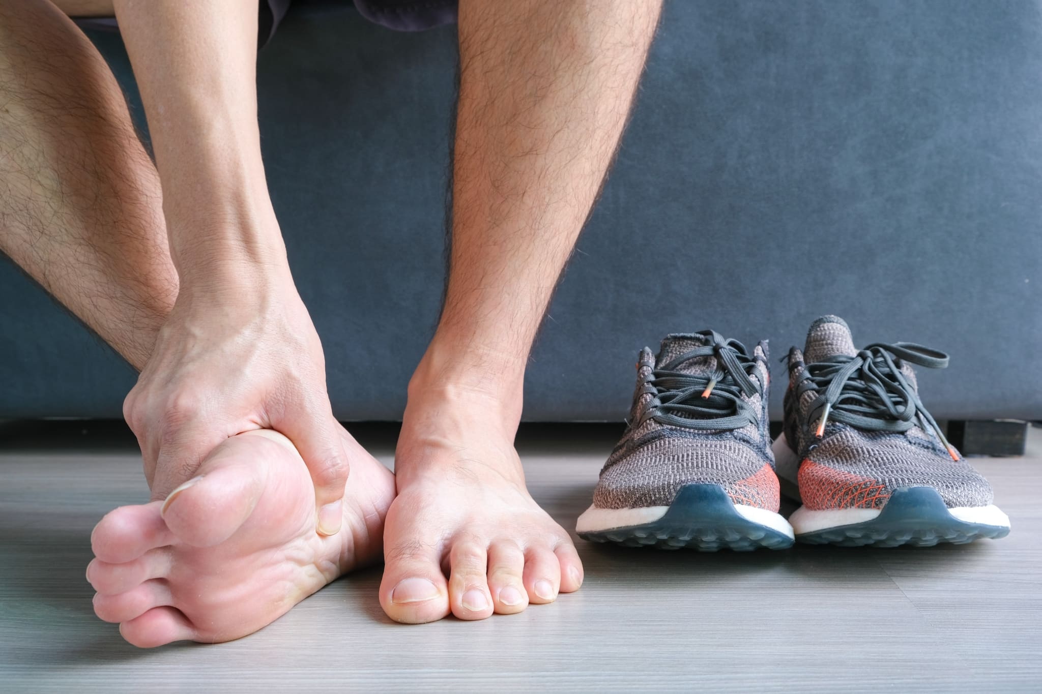 Close up of a man massaging his bare feet