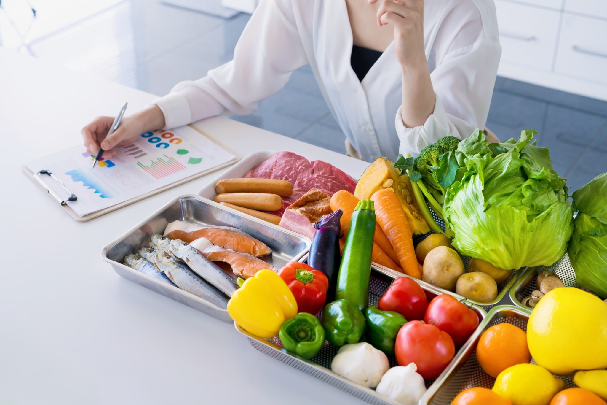 Close up of a woman with trays of healthy food for wellness