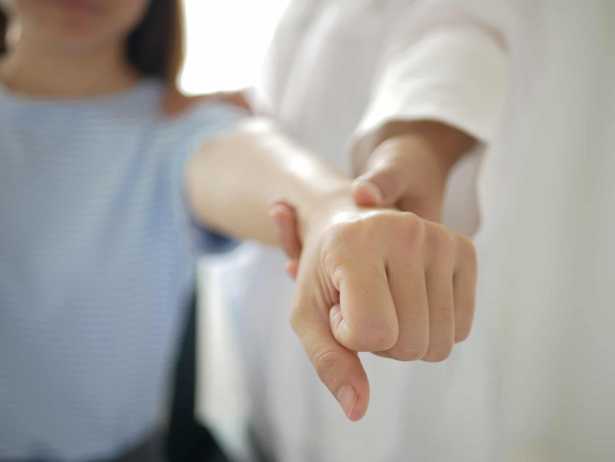 Close up of a woman stretching her arm in physical therapy