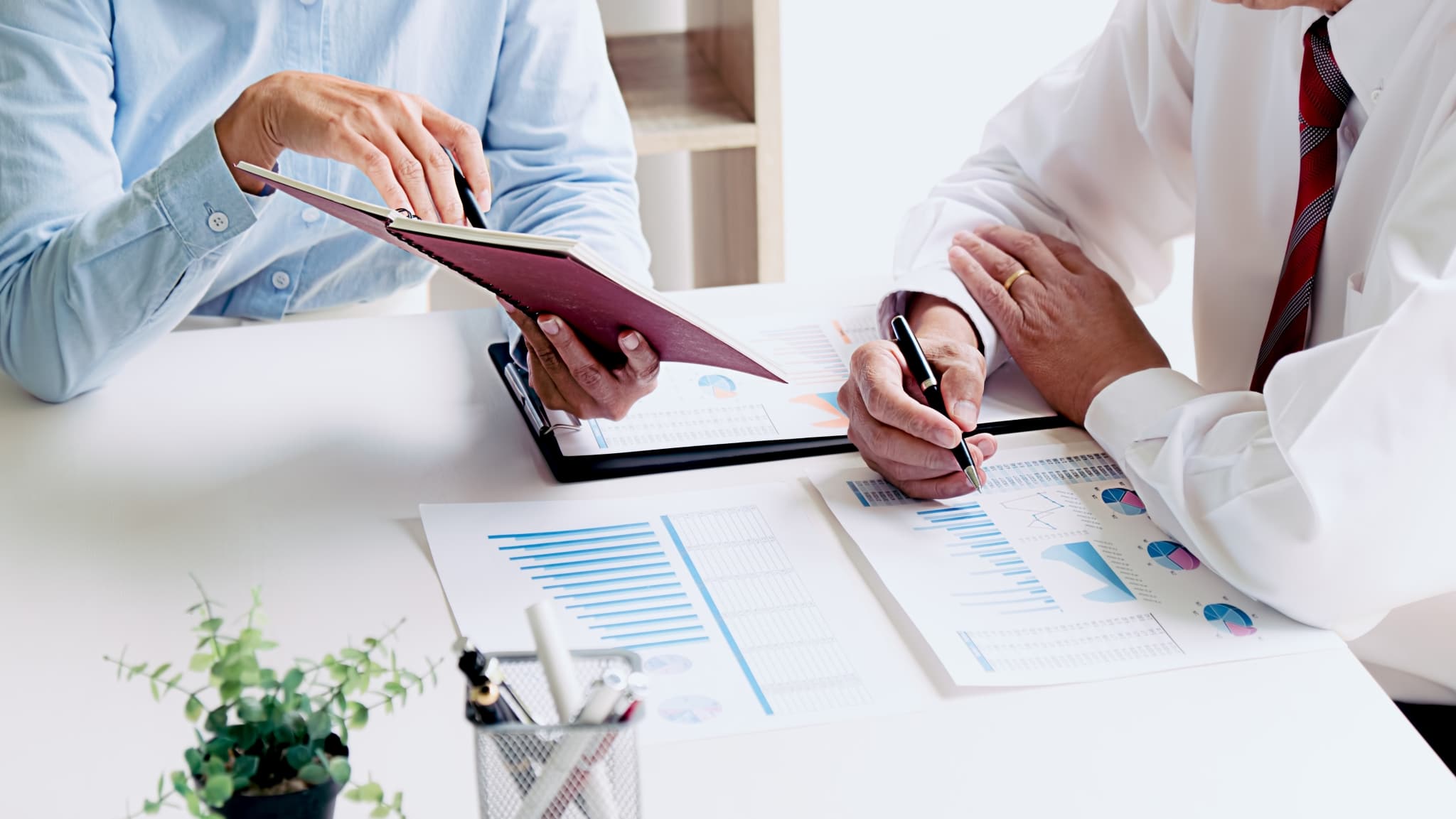 Close up of business professionals looking at job resumes