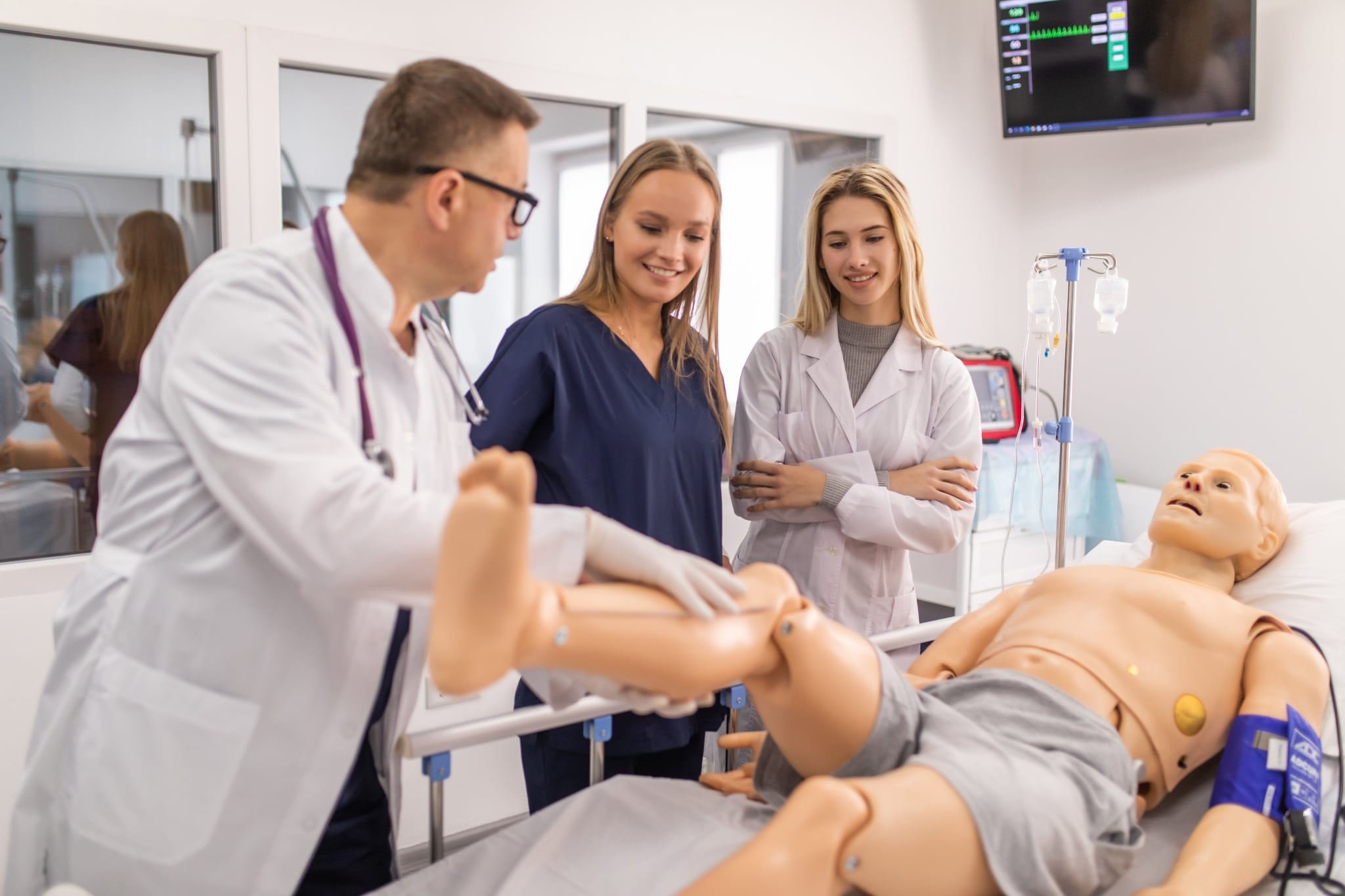 Medical instructor and students in a simulation lab