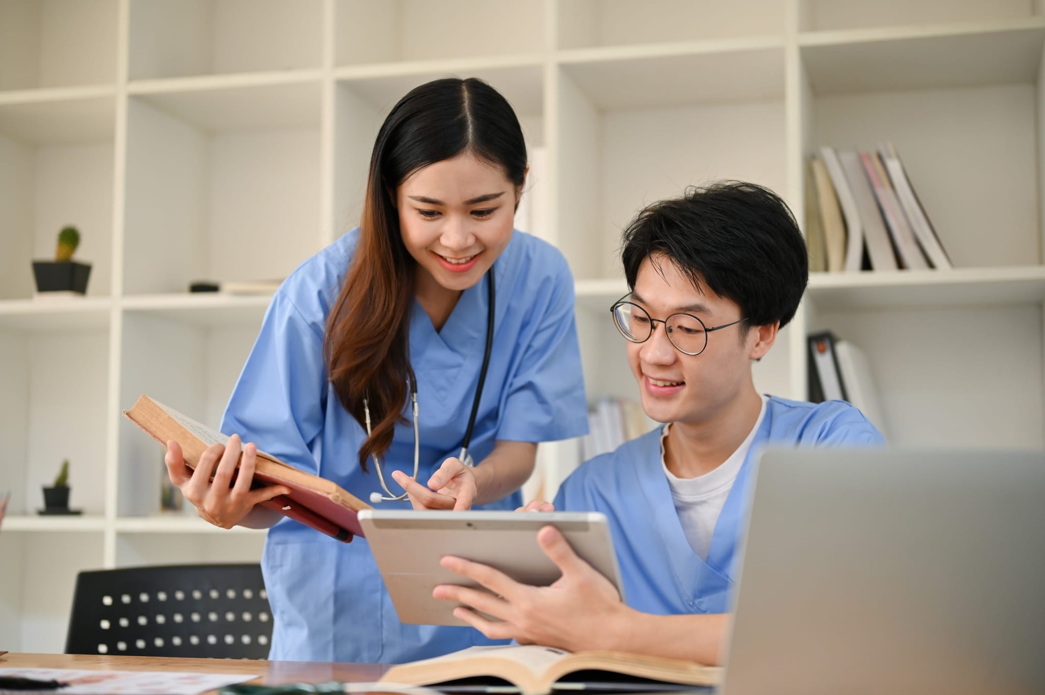Asian medical professionals studying together at a table