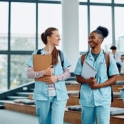 Two smiling medical students in a lecture hall