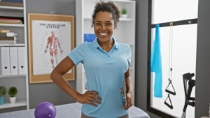 African-American woman standing in a physical therapy clinic