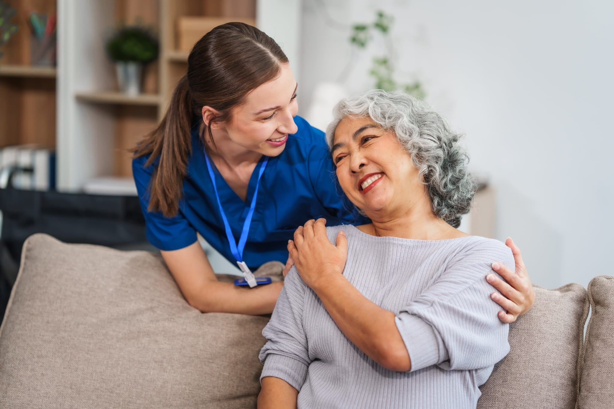 Medical professional touching the shoulder of an older woman