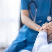 Close up of a medical professional consoling a patient
