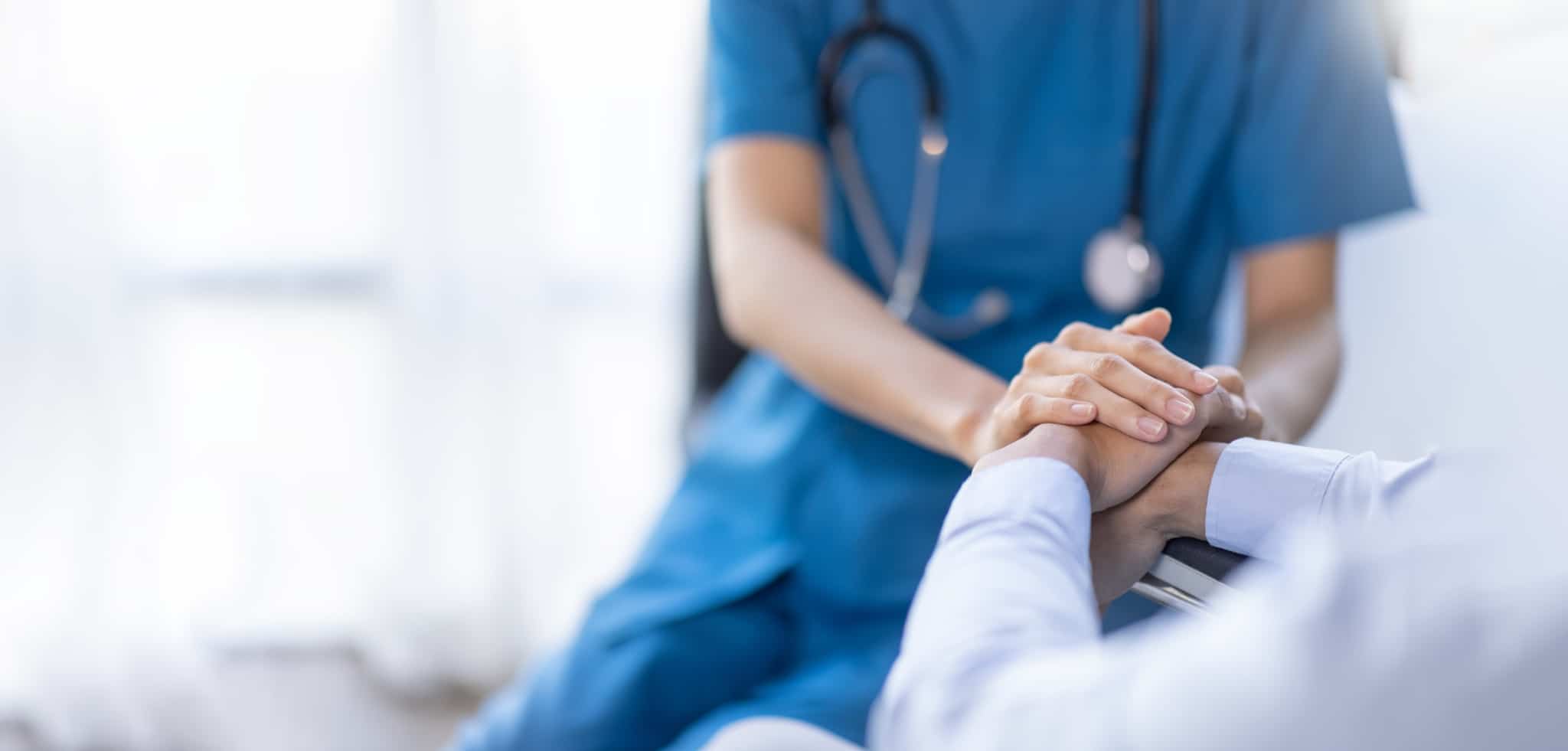 Close up of a medical professional consoling a patient