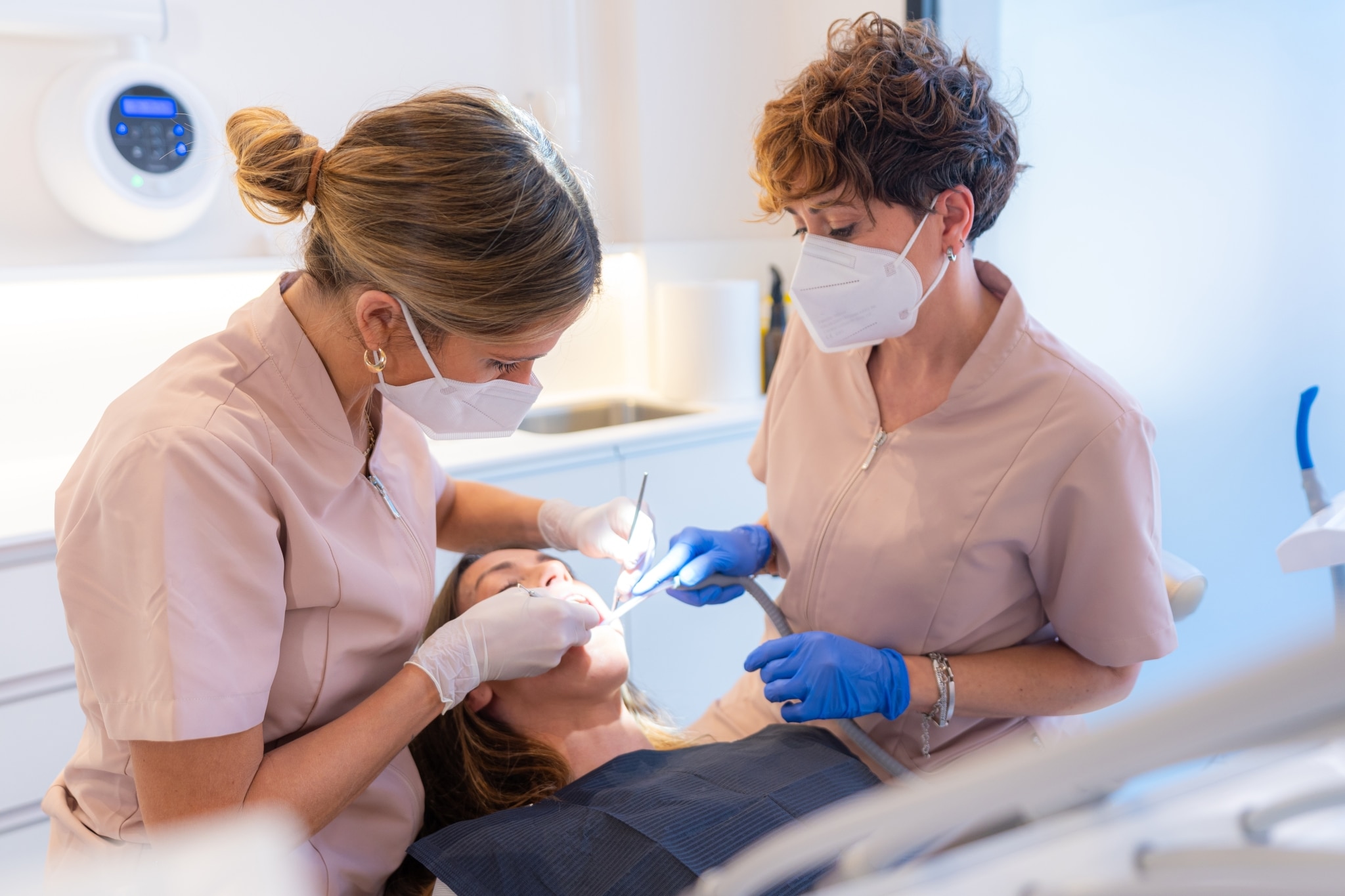 Dental Assistant helping a dental hygienist with a patient