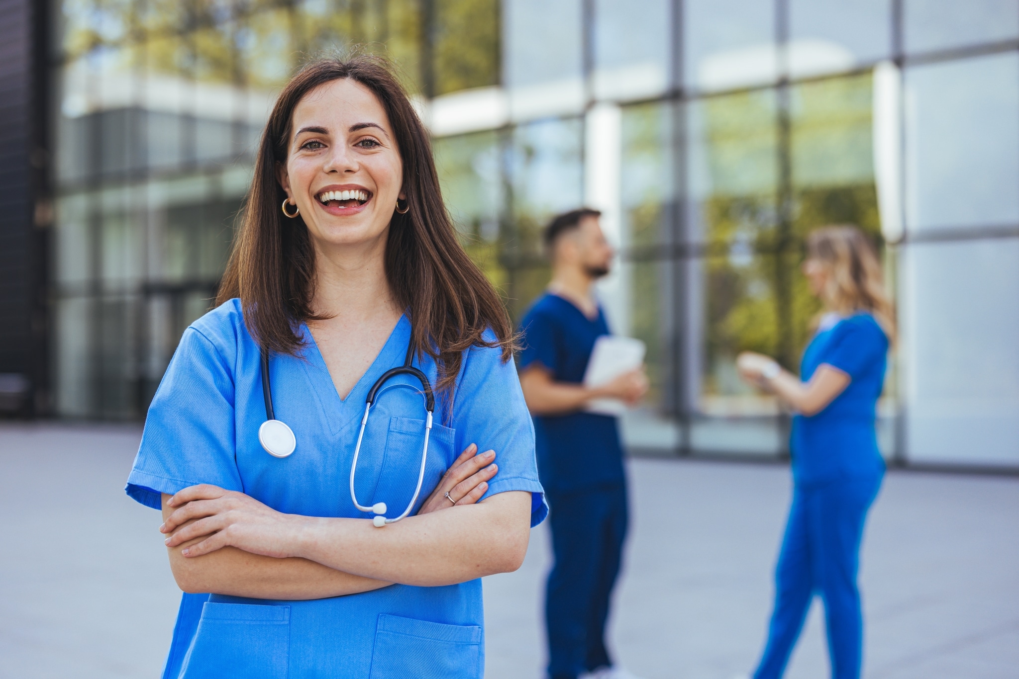 Cheerful medical professional standing outside of a hospital