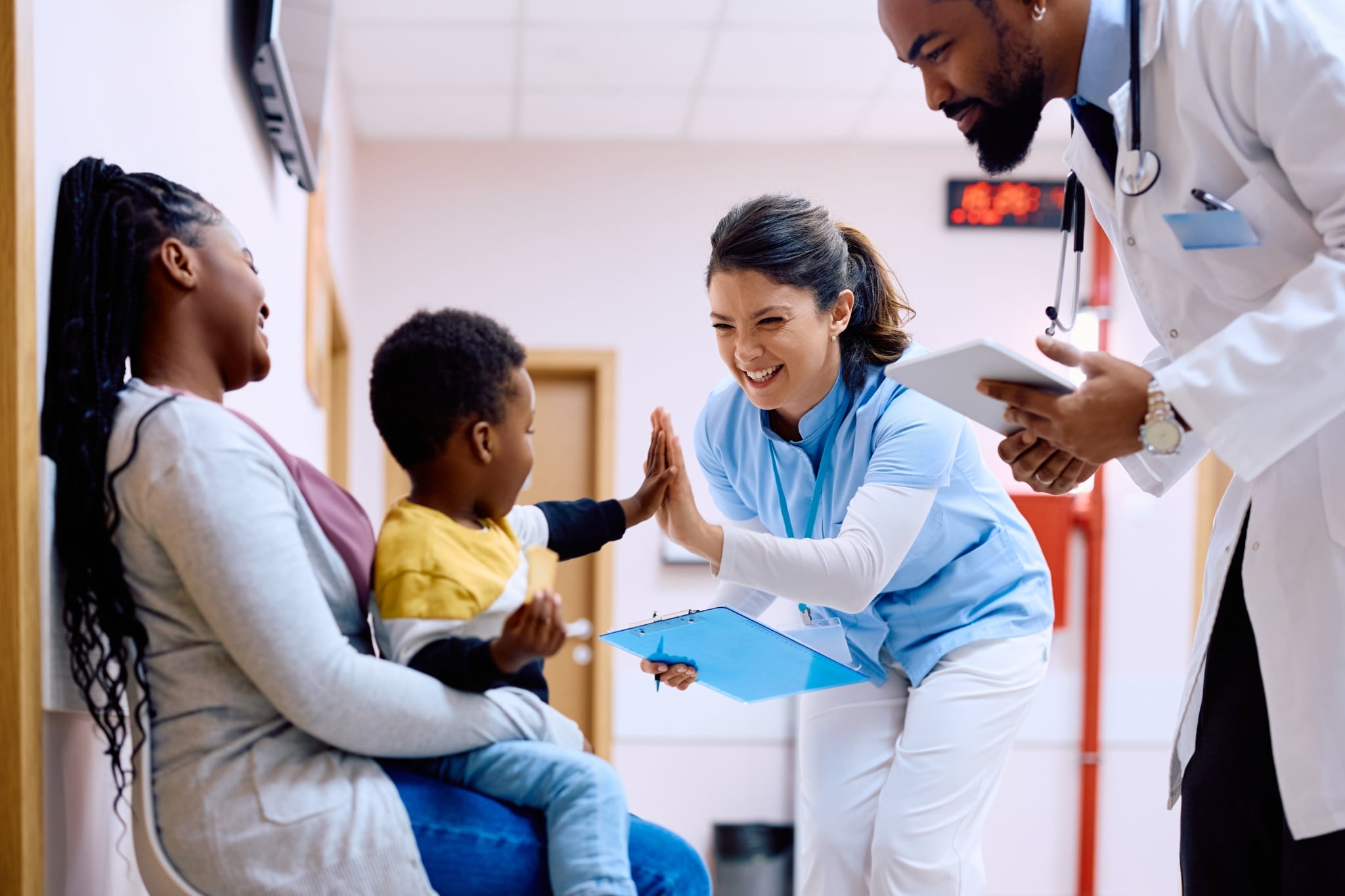 Medical professional giving a high five to a child