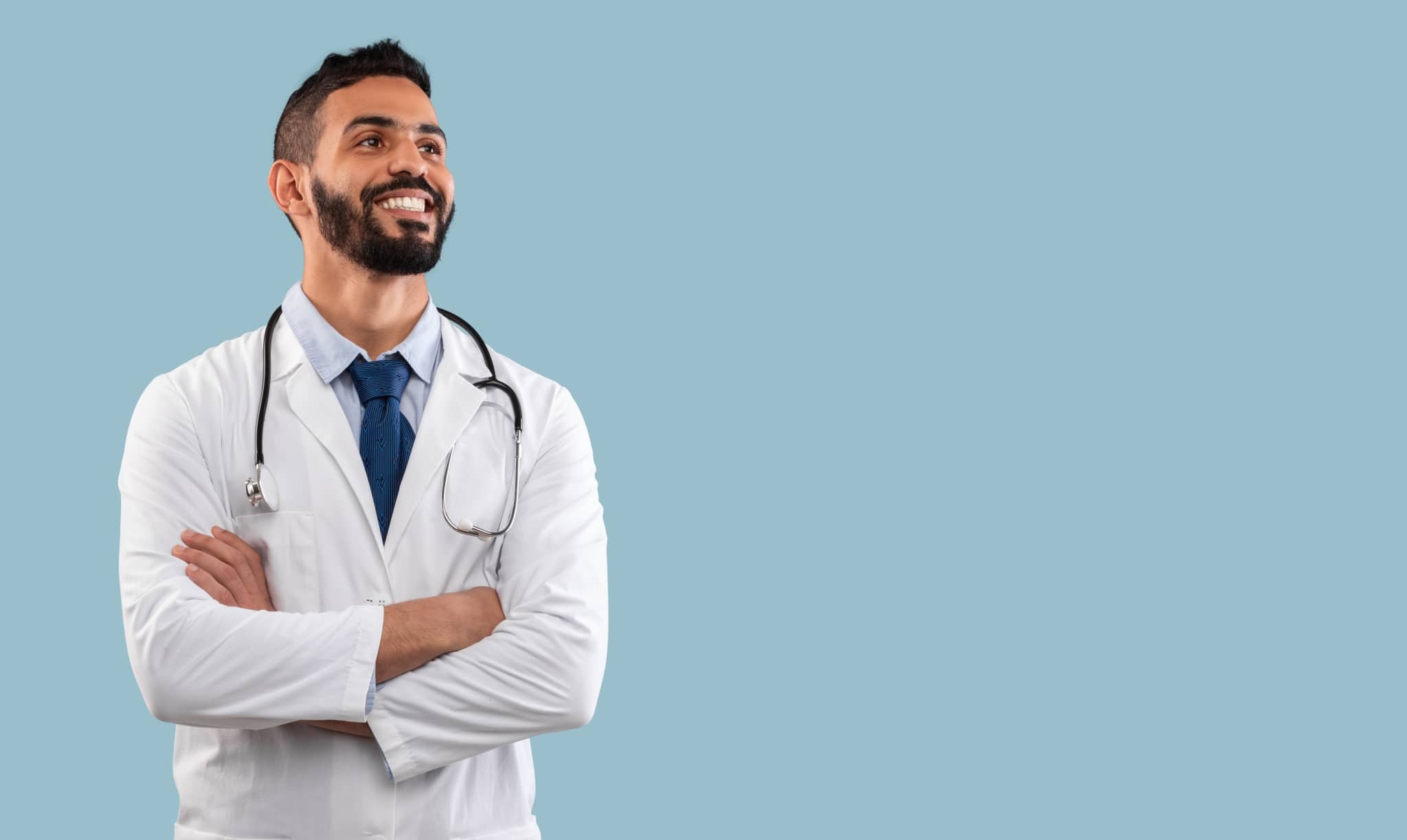 Happy Egyptian physician looking off to the side