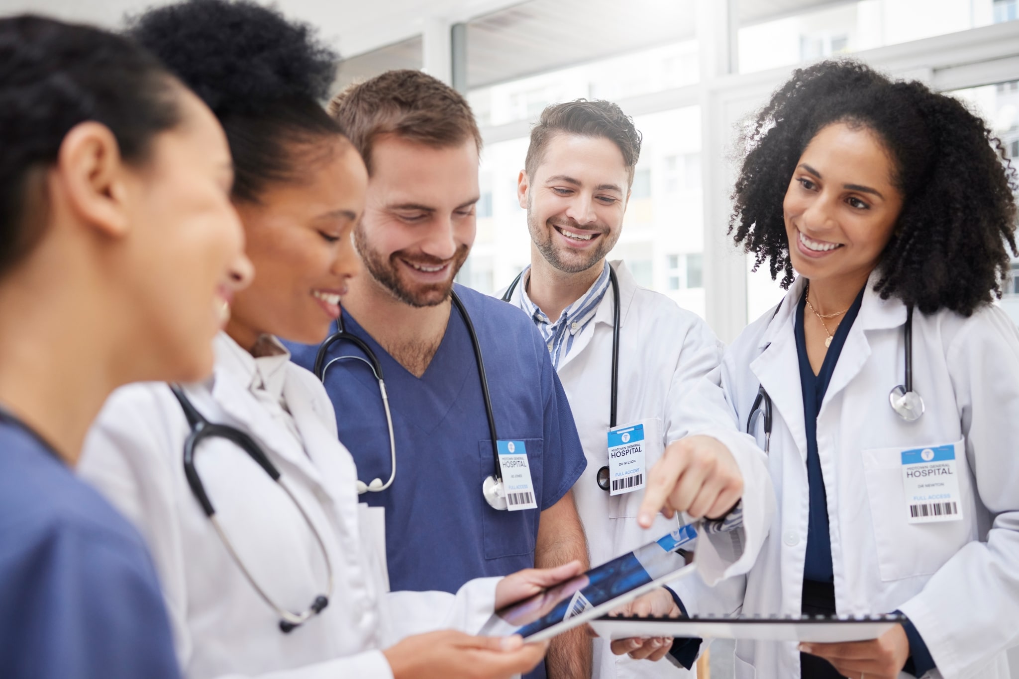 Medical professionals gathered around a tablet