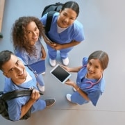 Overhead view of smiling medical students in a hallway