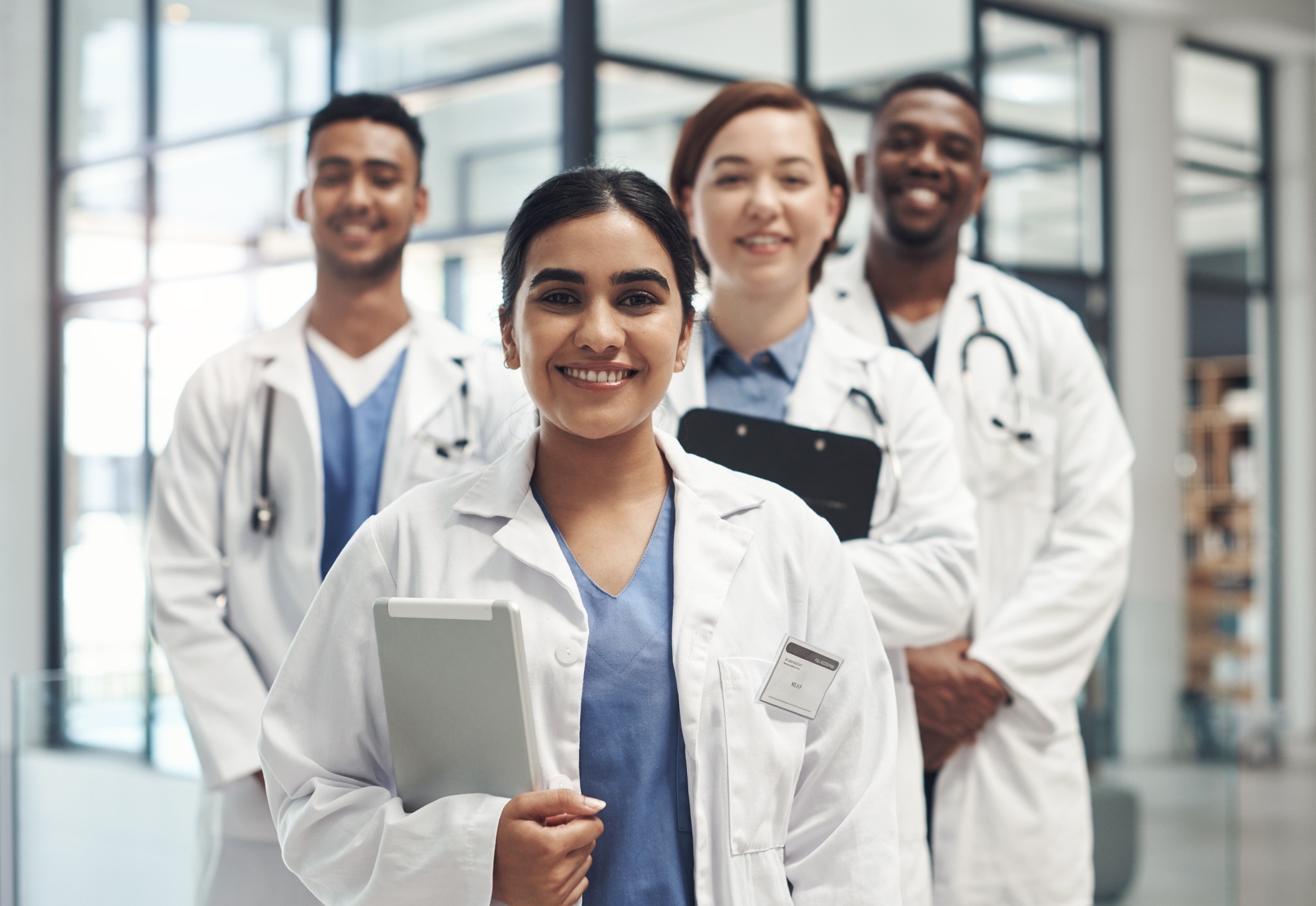 Diverse team of medical professionals with clipboards