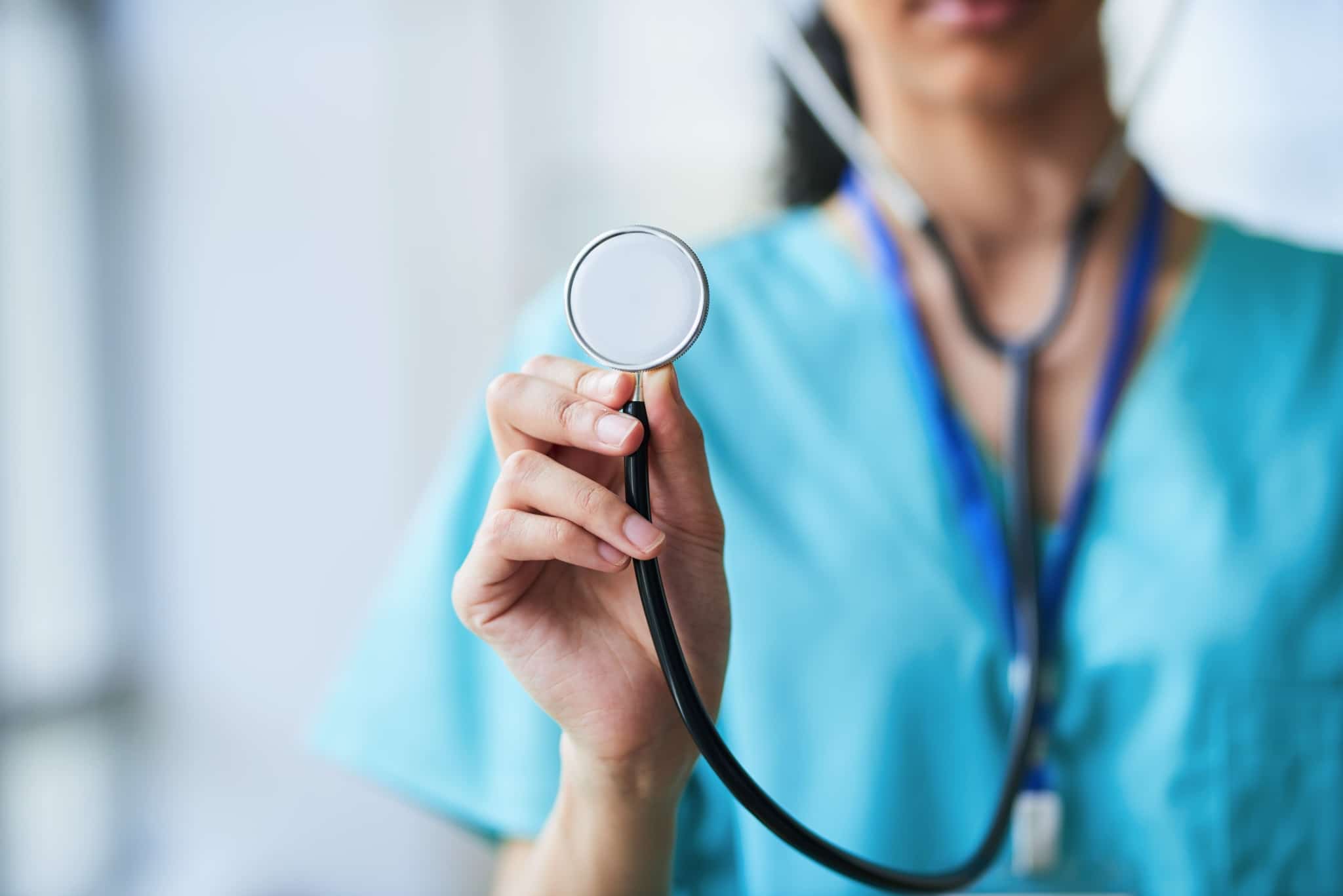 Close up of a nurse holding a stethoscope