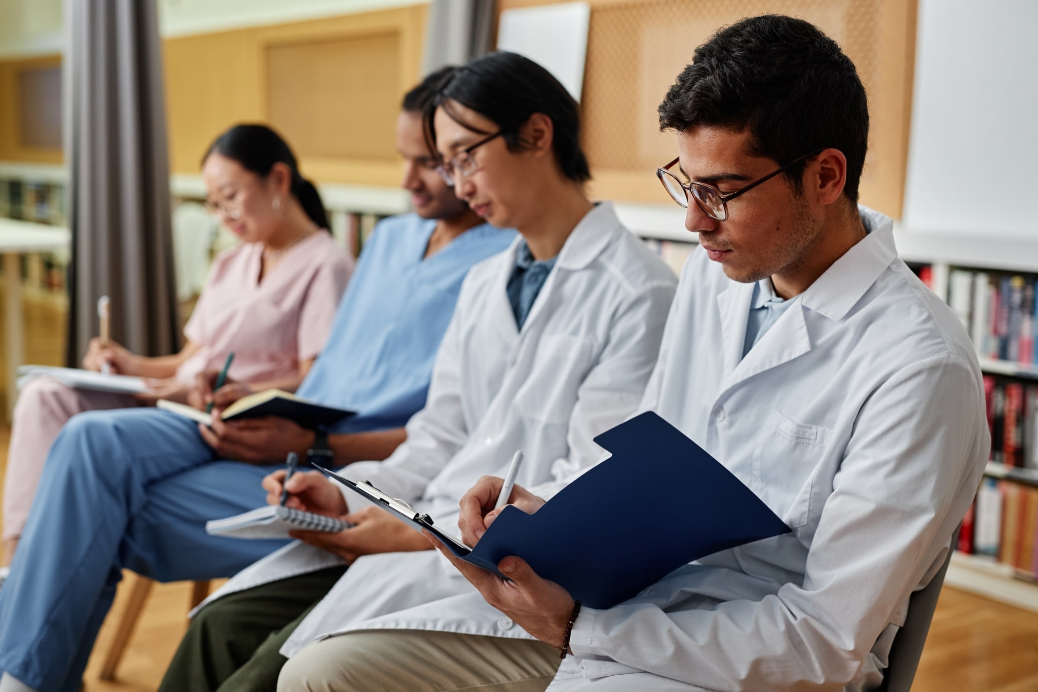 Group of medical students taking notes during a lecture