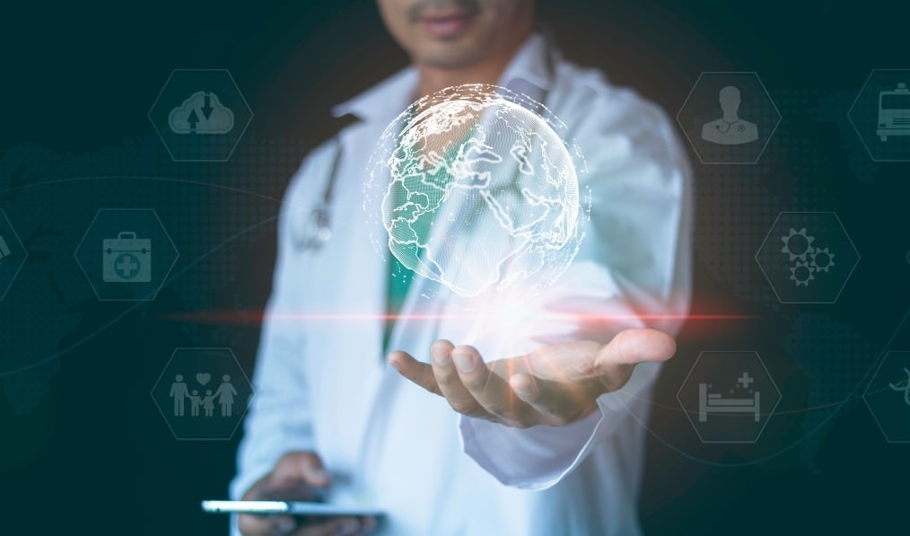 Medical professional holding his hand under virtual healthcare symbols