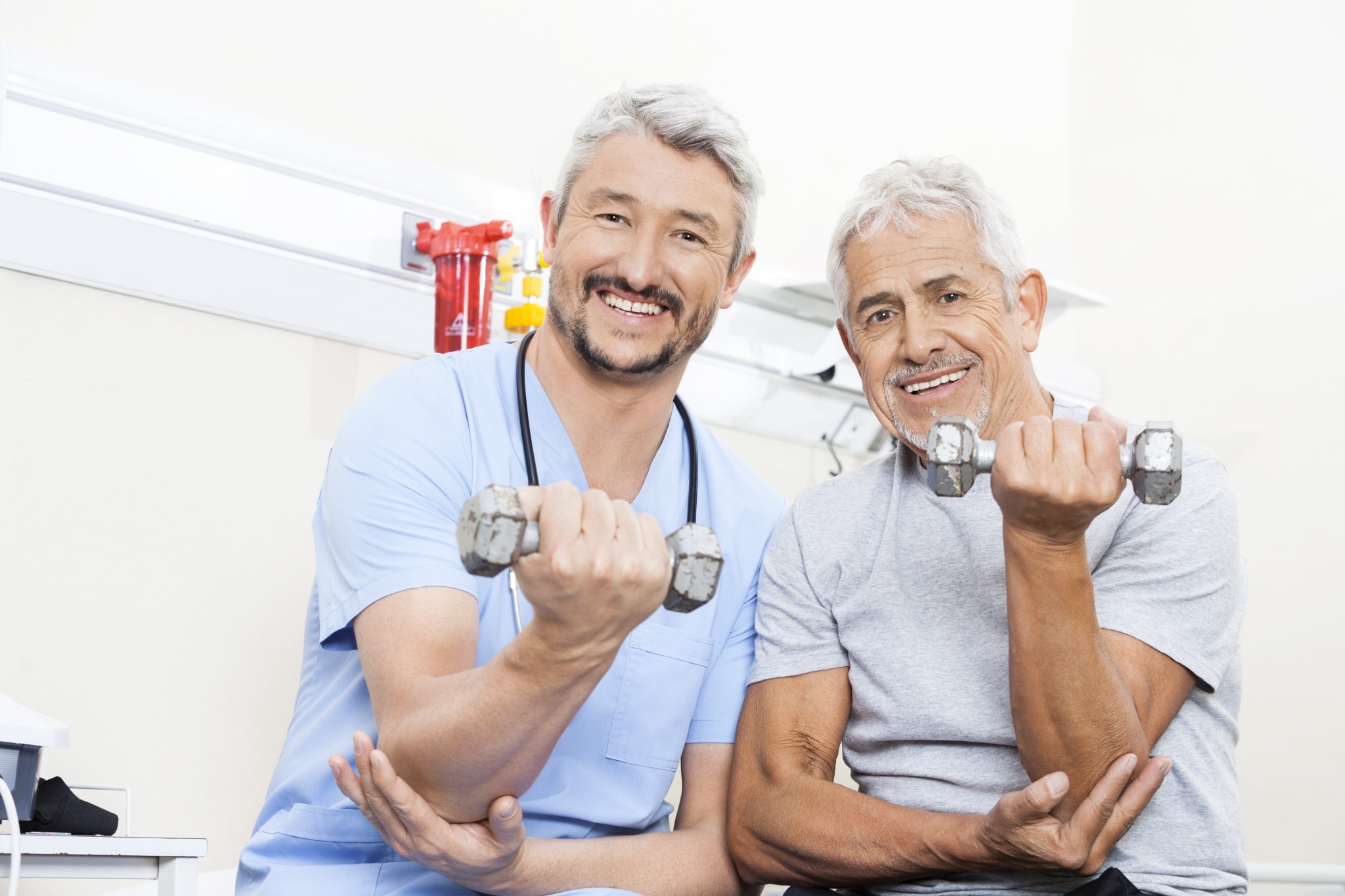 Occupational Therapy Assistant with a male patient lifting weights