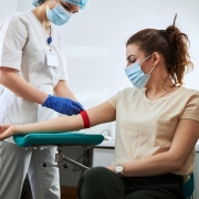 Phlebotomist drawing blood from a woman