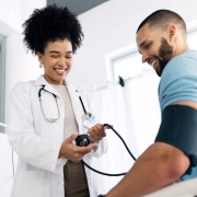 African-American doctor measuring a man's blood pressure