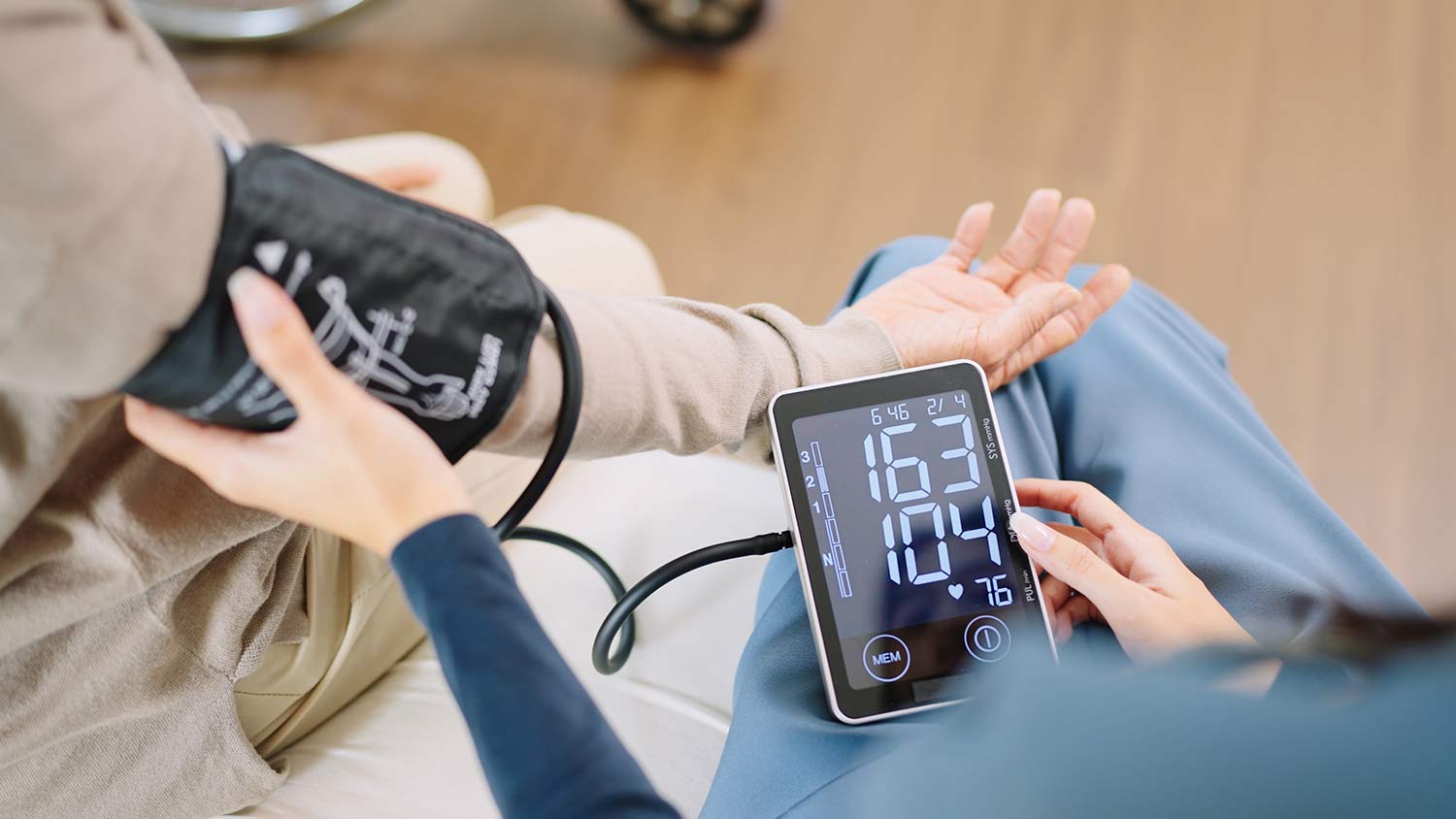 Close up of a nurse taking a patient's blood pressure