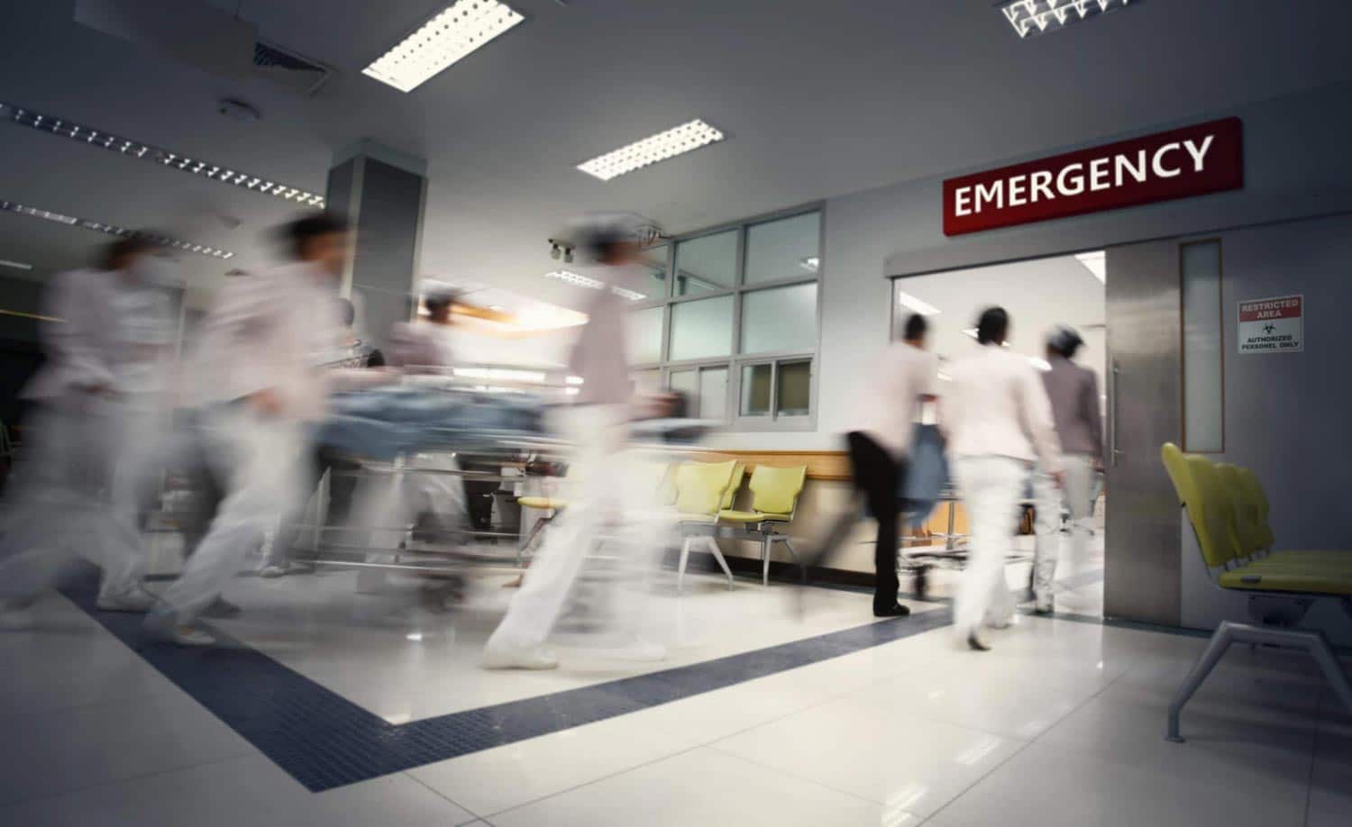 Blurred medical professionals running in an emergency room