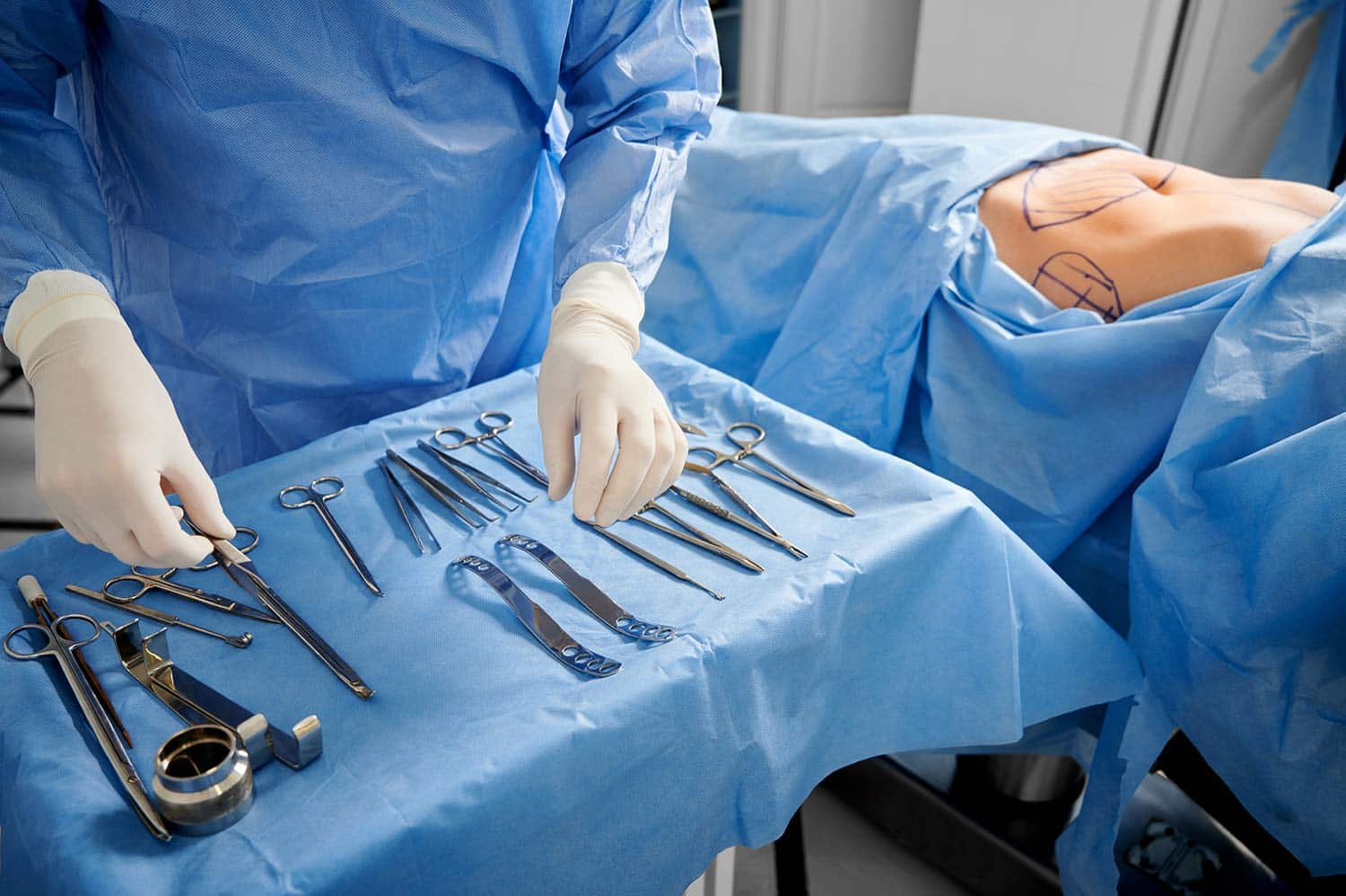 Close up of a medical professional arranging surgical equipment